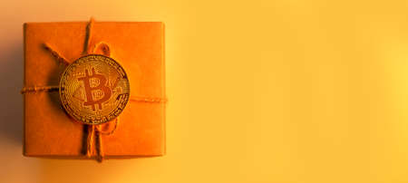 Bitcoin coin on gift box or present, monochrome yellowの写真素材
