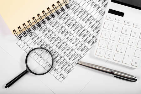 Flat lay of calculator and documents for accounting report of cash flow.
