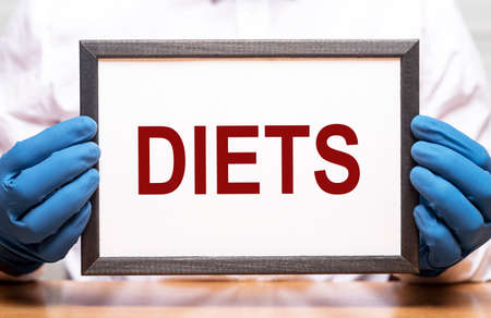 Diets word in doctor hands, dieting concept.の写真素材