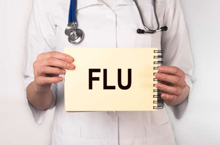 Flu word, inscription in doctor hands. Medical conceptの写真素材