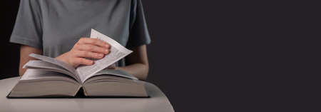 Female student hands closeup, turning pages of thick book, seeking for information and reading at...