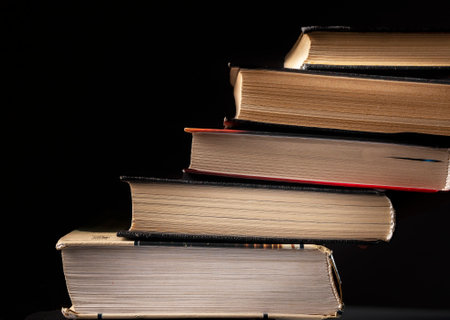 Concept of progress in education, reading. Stairs from stack of books on black background.の写真素材