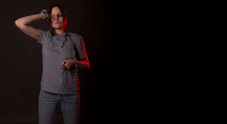 Young woman ties with chain, suffer from despair, psychological problems. Unhappy person with heavy...