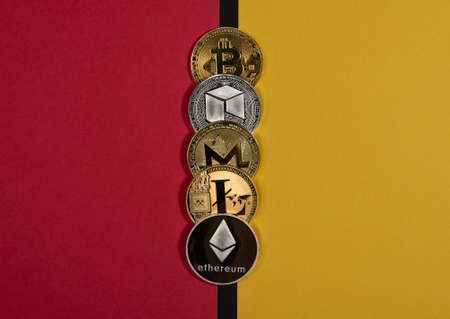 Different shining cryptocurrency coins, crypto currency concept. Pros and cons, pluses and minuses, two sides. Bitcoin, litecoin, ethereum, monero and NEO.の写真素材