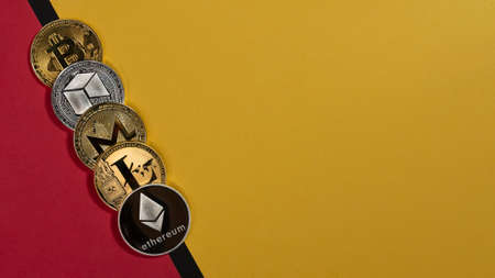 Different shining cryptocurrency coins, crypto currency banner on yellow and red banner with copy space for text.の写真素材