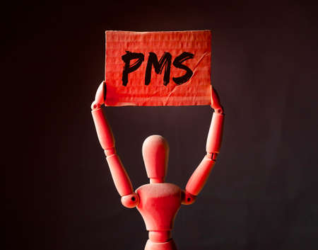 PMS acronym, premenstrual syndrome inscription in red light.の写真素材