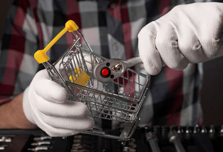 Concept of metal repair tool shopping. Choosing socket ratchet handle.