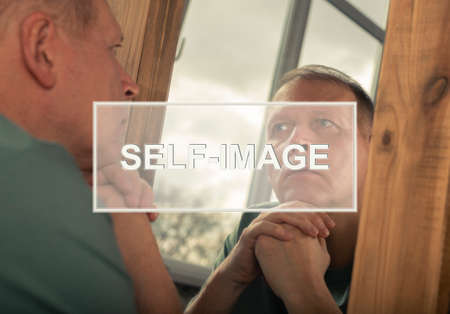 Self-image and perception word on photo with mature man thinking about himself, his identity and personality. Psychological concept.の写真素材