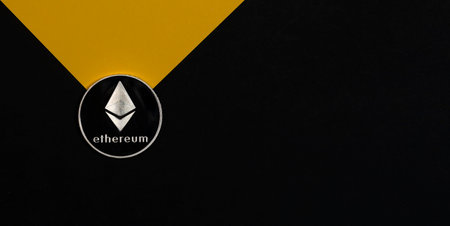Ethereum or eth silver coin on black and yellow banner with copy space for text and light beam....
