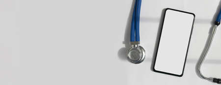 Mobile phone mock up with sthethoscope over white background. Template with white screen of...