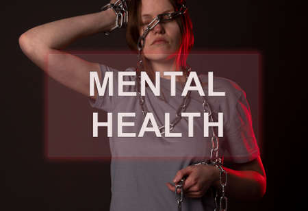Mental health inscription on photo of woman in chains.の写真素材