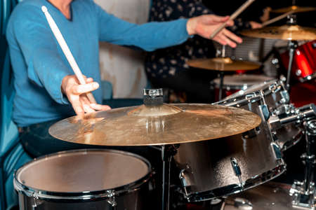 Male drum player hands holding cymbals with both hands and sticks. Drummer.の写真素材