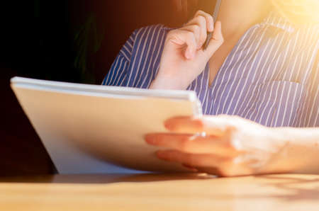 Women hands thinking and writing ideas in notebook.の写真素材