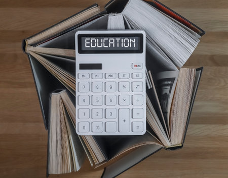 Financial education concept. Word on calculator with books on accounting and finance.の写真素材