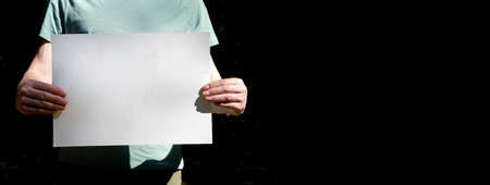 Placard mockup in male hands. Banner with copy space.の写真素材