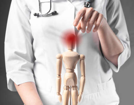 Headache concept. Red pain of head ache on wood dummy.の写真素材