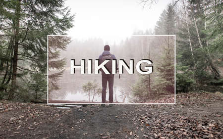 Hiking concept. Text for web site header on photo with man hiker in forest near lake in autumn.の写真素材