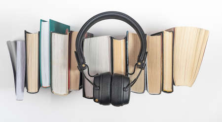 Audio books stack with headphones, top view. Audiobook reading concept.の写真素材