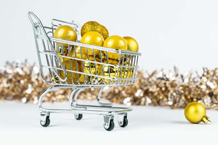 Shopping cart full of Christmas baubles, Xmas ornament composition.の写真素材