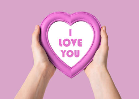 I love you message on pink heart in women hands. Valentines day card.の写真素材