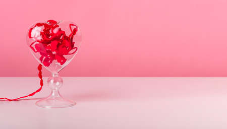 Valentines day concept. Banner with hearts ribbon on pink background. Abstract romantic composition with copy space. High quality photoの写真素材