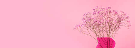 Pink gentle flowers in vase on ad banner with copy space for text.の写真素材