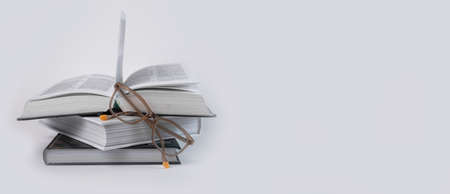Banner with books stack and eyeglasses. Education and reading concept. Place for text. High quality photoの写真素材