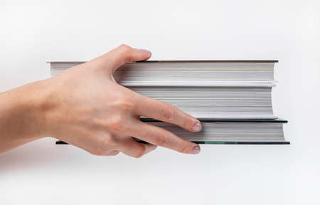 Hand holding books stack. Education and reading concept. High quality photoの写真素材