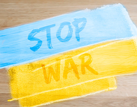 Stop War text on blue and yellow Ukrainian flag. photoの写真素材