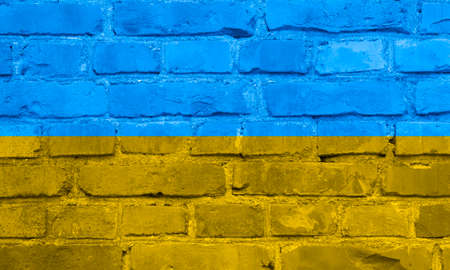 Blue and yellow Ukraine flag on brick wall, photo.の写真素材