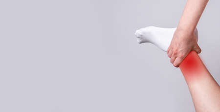Banner with ankle pain with red spot. Foot injuries. Sport, household traumas to bones, ligaments or...