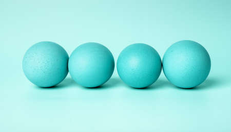 Blue dyed Easter eggs on mint background. Celebration of Christian feast concept. High quality photoの写真素材