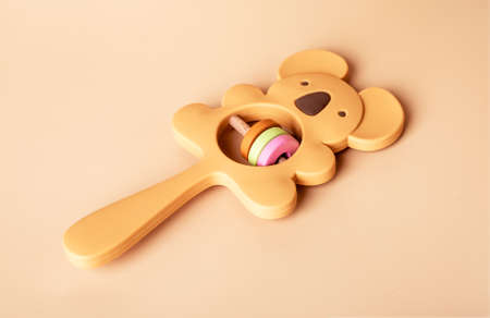 Wooden eco beanbag rattle and teether in koala shape. Baby accessory on beige background. Organic toy for newborn. High quality photoの写真素材