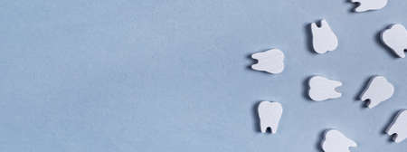 Banner with white teeth. Oral hygiene, dental care, stomatology concept on blue background. Copy...