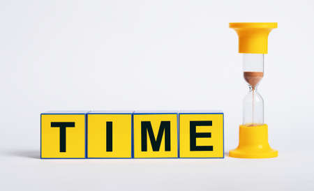 Hourglass and cubes with word time. Sand clock measuring one minute passage. Deadline and...
