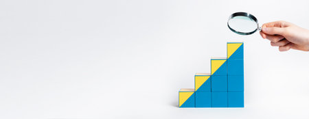 Banner with hand holding magnifier over career ladder from cubes. Study of professional development...