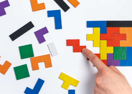 Hand doing puzzle. Critical thinking, decision making, concentration concept. Important missing element adding. High quality photoの写真素材