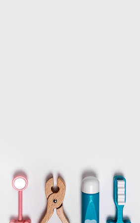 Banner with dentist and tooth cleaning tools. Health care concept. Nippers, mirror, paste, brush. Dental instruments set for kids. Place for text. High quality photoの写真素材