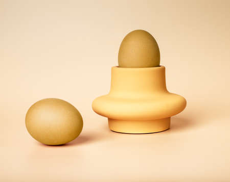 Golden dyed Easter eggs in server and on beige background. Nutritious healthy food for religious holiday breakfast. High quality photoの写真素材