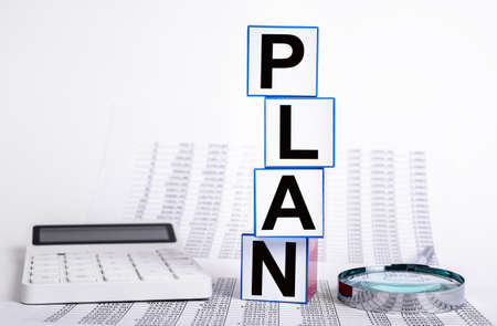 Business financial plan concept. Statistics papers with calculator and magnifier. Company revenue,...