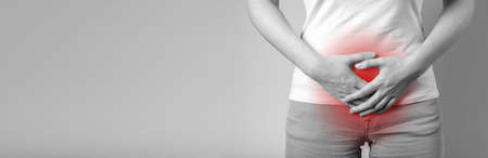 Menstruation cramps, PMS and gynecological problems. Banner with woman hands holding lower abdomen...