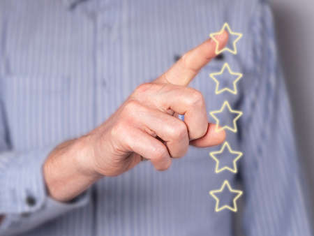 Man hand giving feedback. Star rating of service quality at virtual screen. Customer satisfaction...
