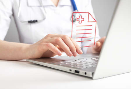 Doctor working with medical document online on laptop, reporting test results or prescription to patient. Records in clinic or telemedicine, telehealth concept. High quality photoの写真素材