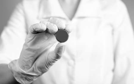 Doctor holding pill. Erroneous medication prescription, wrong dosage or medical decision,...