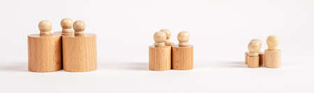 Hierarchy, ranking, teamwork concept. Row of Montessori knobbed cylinders placed in groups depending...