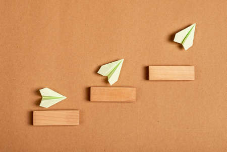 Progress, development concept. Origami planes flying up stairs. Professional, personal growth,...