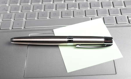 memo note and pen on laptops keyboard. High quality photoの写真素材
