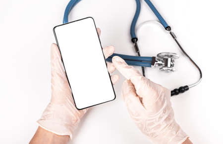Stethoscope and doctor hands holding phone mockup for online medical consultation, communication...