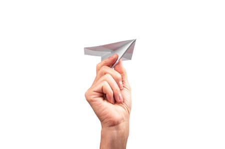 Woman hand throwing origami plane isolated on white background. Handmade flying paper construction. Optimism, childhood concept. High quality photoの写真素材