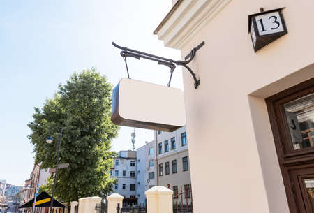 Old city signboard mockup. Beautiful downtown in sunlight. Retro board of rectangle shape on restaurant, hotel, museum wall. High quality photoの写真素材